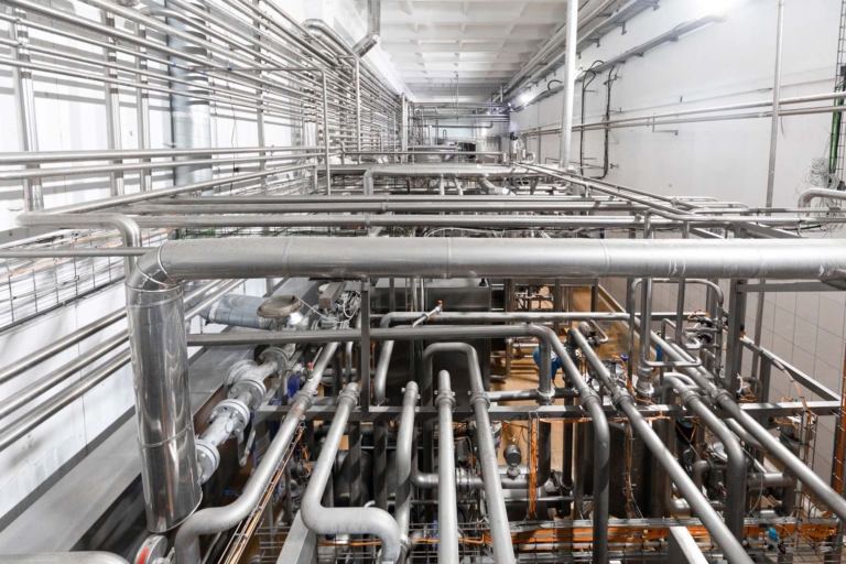Metallic pipes isolated on factory background